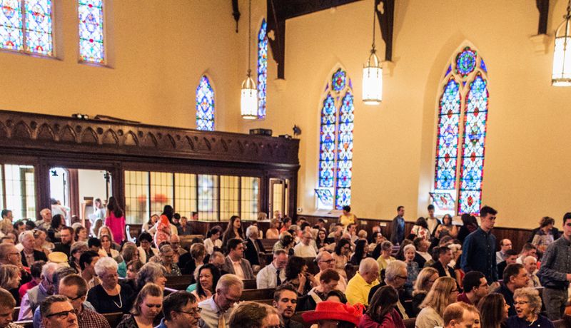 church congregation and stained glass windows