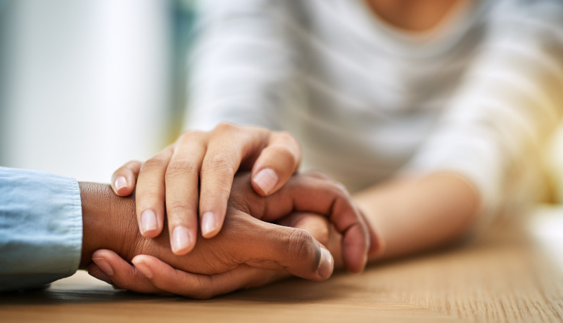 clasped hands - two people