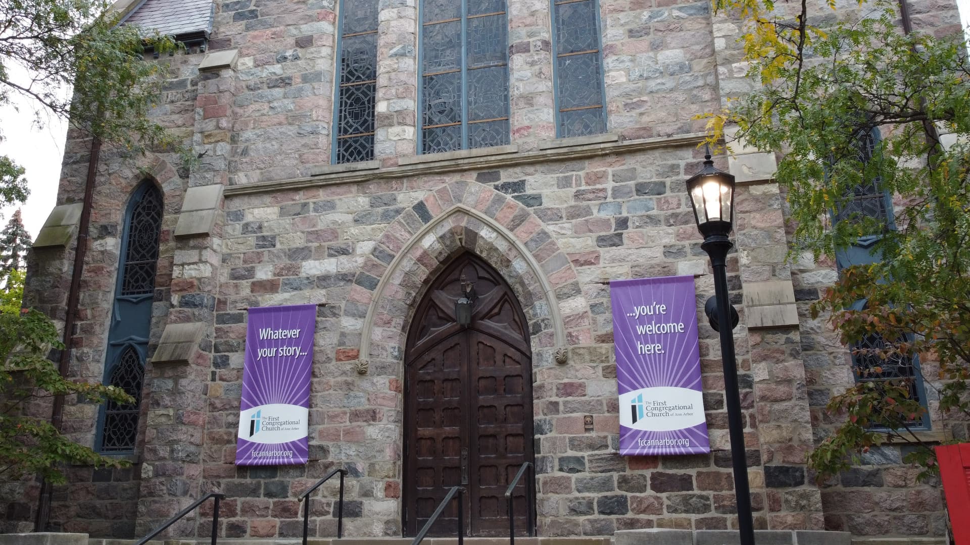 Front doors of FCC Ann Arbor with banners that read No matter your story, you're welcome here.